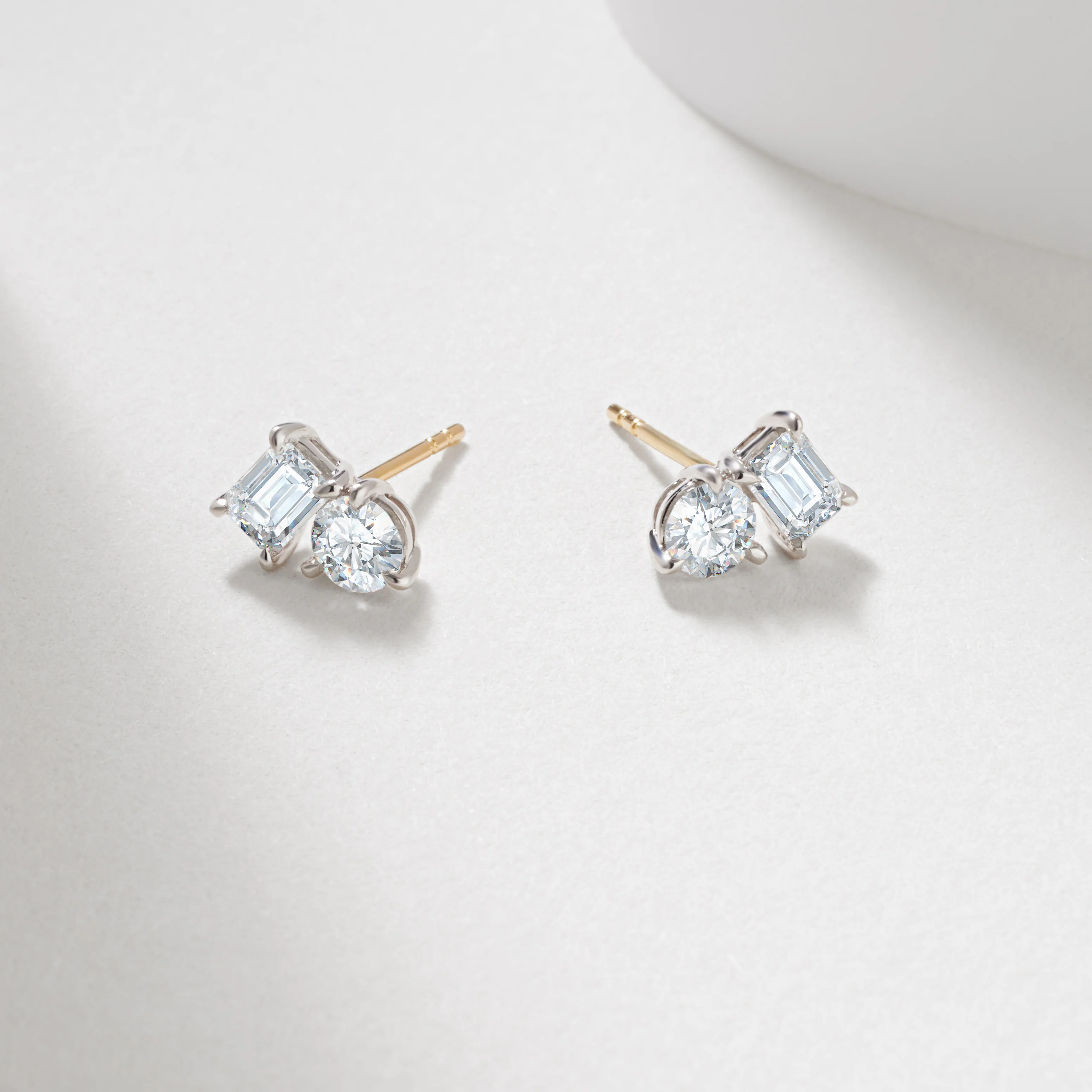 9WY 1.49tdw emerald and round lab diamond claw set toi et moi stud earrings