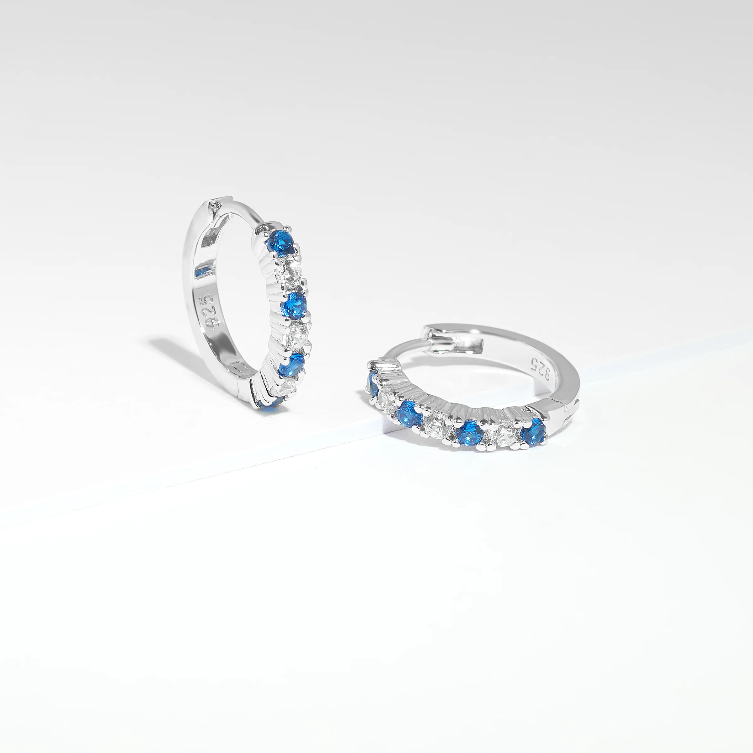 Sterling Silver Blue And White Zirconia Huggie Earrings - Image 2