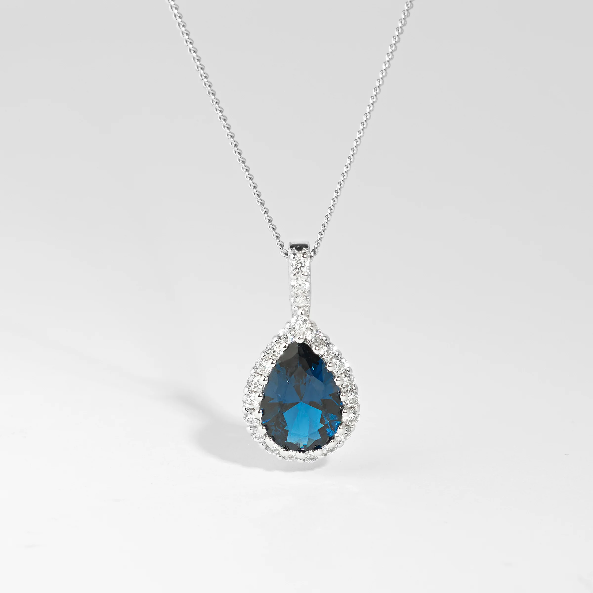 Sterling Silver London Blue Pear And Zirconia Halo Pendant